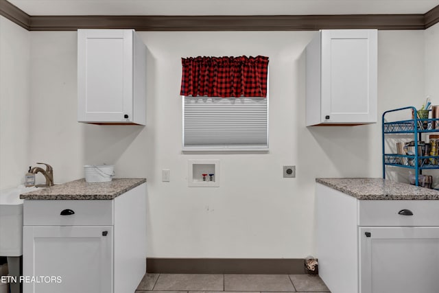 clothes washing area featuring cabinets, hookup for a washing machine, ornamental molding, electric dryer hookup, and light tile patterned flooring