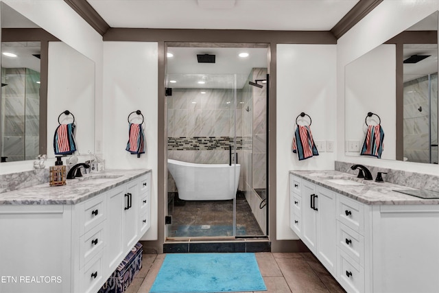 bathroom with tile patterned flooring, vanity, and separate shower and tub