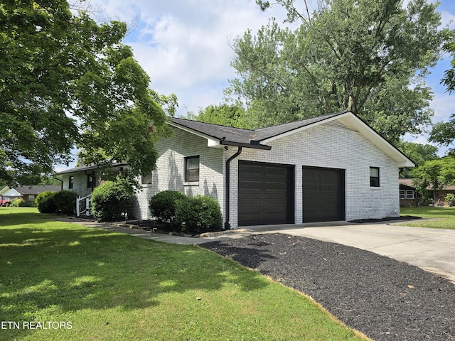 view of front of home featuring a garage and a front lawn