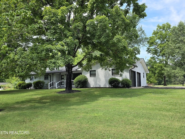 view of front of house with a garage and a front yard