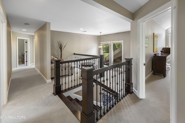 hallway featuring recessed lighting, baseboards, an upstairs landing, and carpet floors