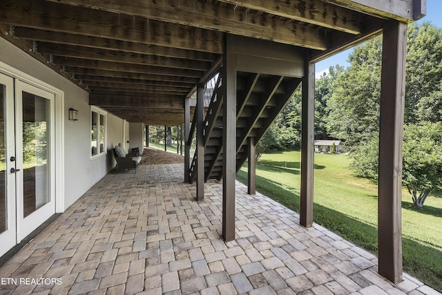 view of patio / terrace featuring french doors and stairs