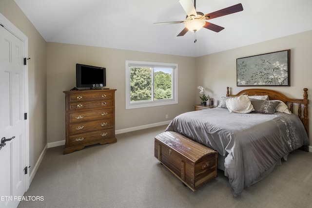 carpeted bedroom with baseboards, lofted ceiling, and ceiling fan