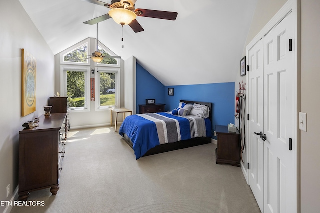 carpeted bedroom featuring lofted ceiling and ceiling fan