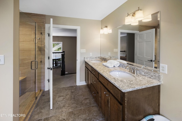 bathroom featuring a sink, a stall shower, and double vanity