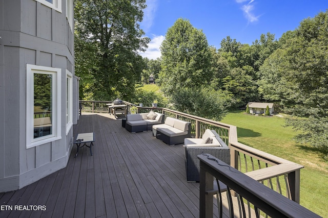 wooden terrace with a lawn and outdoor lounge area