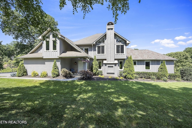 view of front of house featuring a front lawn, board and batten siding, and a chimney