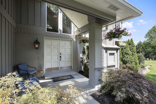 view of exterior entry with brick siding