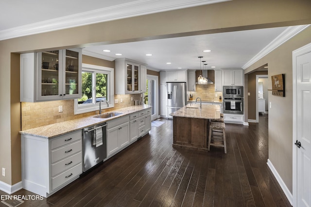 kitchen featuring dark wood-type flooring, ornamental molding, a sink, stainless steel appliances, and baseboards