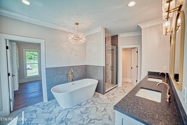 bathroom featuring crown molding, a stall shower, marble finish floor, and a sink