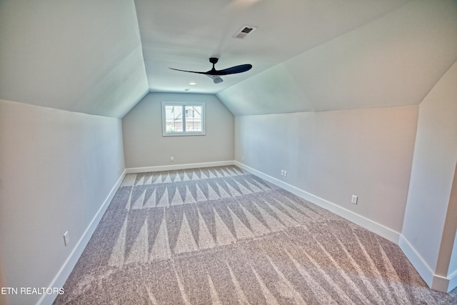 bonus room featuring lofted ceiling, visible vents, baseboards, and carpet flooring