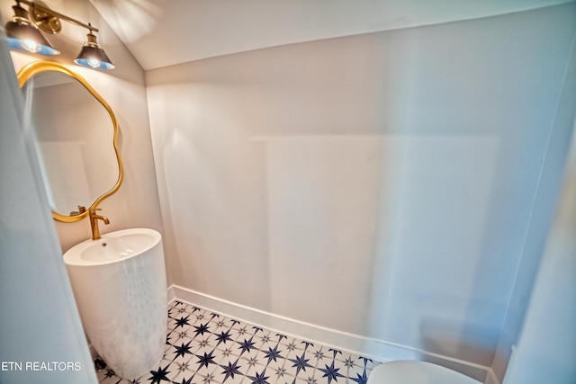 bathroom with tile patterned floors and baseboards