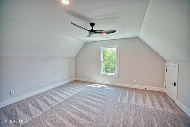 bonus room with lofted ceiling, carpet, baseboards, and a ceiling fan