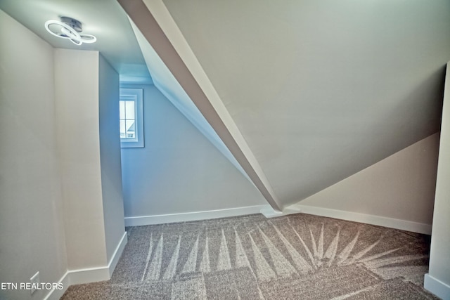 additional living space with vaulted ceiling, carpet flooring, and baseboards