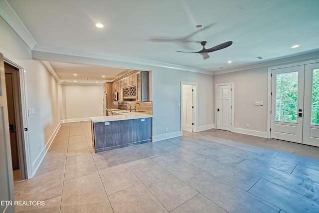 interior space featuring crown molding, light tile patterned floors, recessed lighting, light countertops, and a peninsula