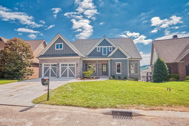 craftsman-style house featuring brick siding, a shingled roof, concrete driveway, board and batten siding, and a front yard