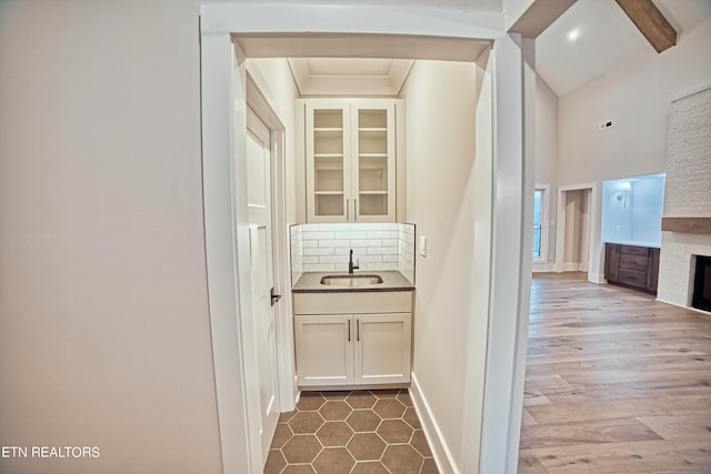 corridor featuring a sink and baseboards