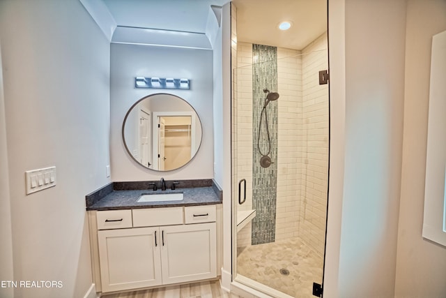 bathroom featuring a shower stall and vanity