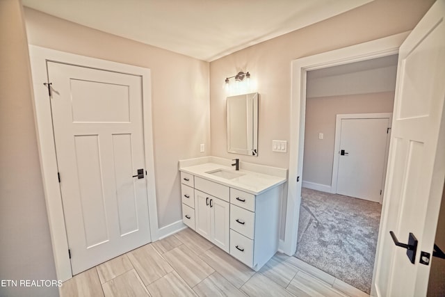 bathroom featuring baseboards and vanity