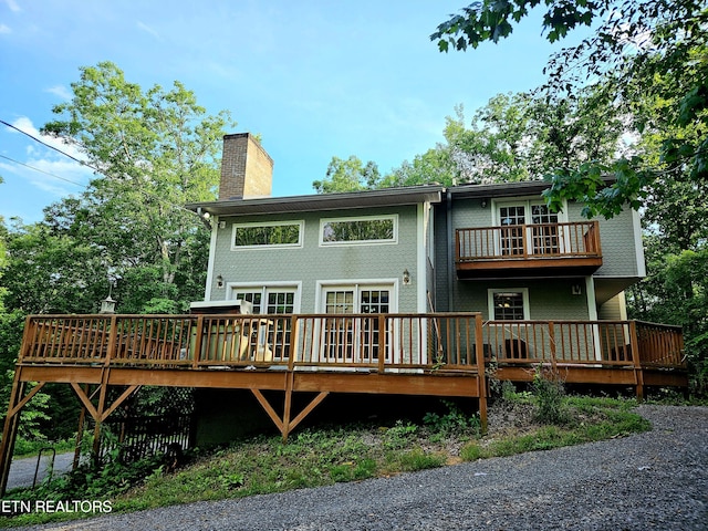 back of property with a wooden deck