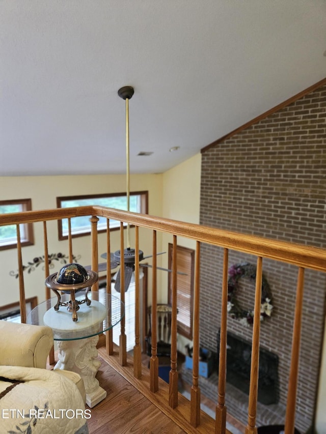 hall with hardwood / wood-style floors and lofted ceiling