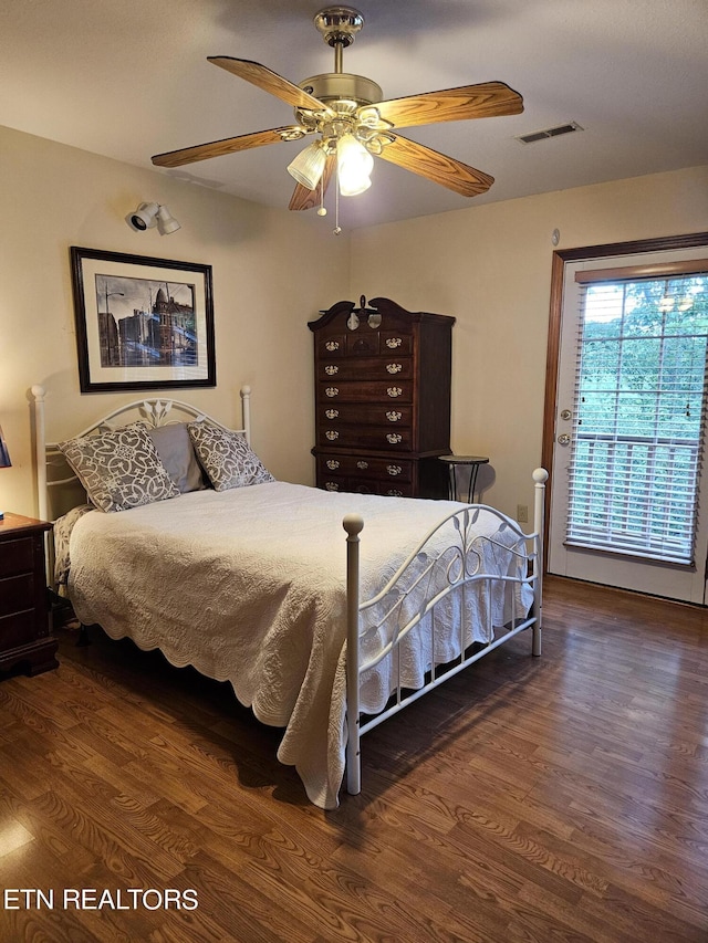 bedroom with ceiling fan and dark hardwood / wood-style flooring