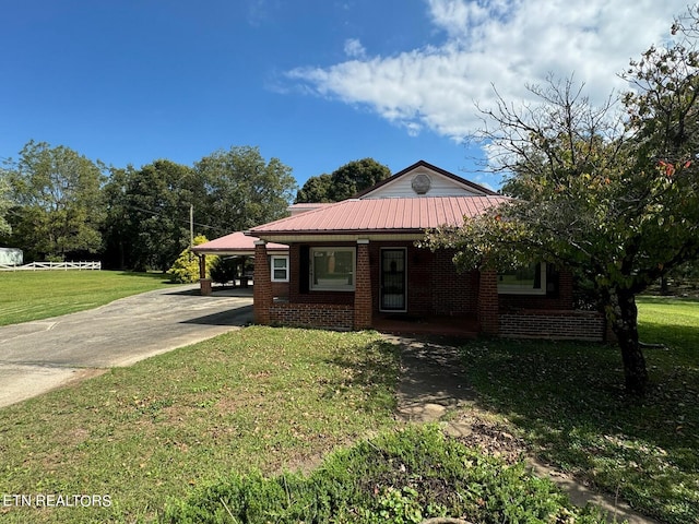 single story home featuring a front lawn and a carport