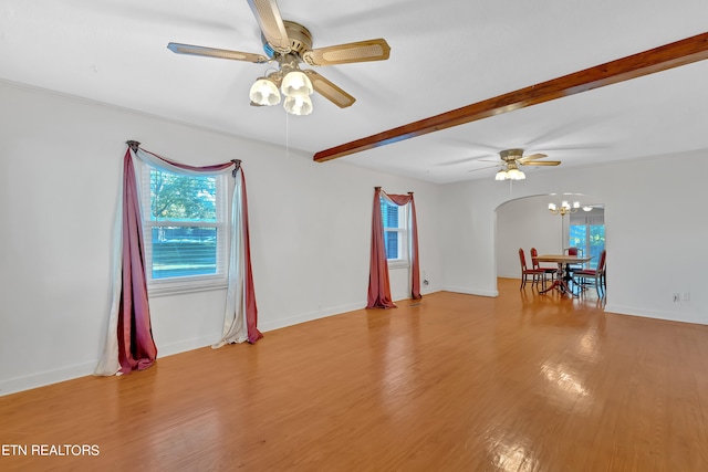 spare room featuring light hardwood / wood-style floors, beam ceiling, and ceiling fan