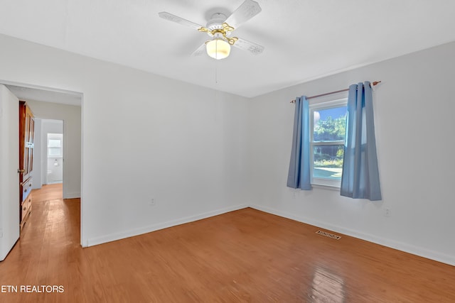 empty room with light hardwood / wood-style flooring and ceiling fan