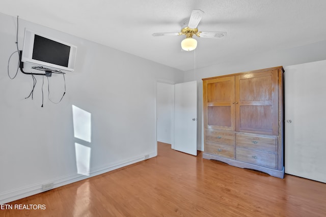 unfurnished bedroom with light hardwood / wood-style floors and ceiling fan