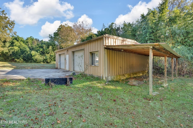 view of outbuilding with a lawn and a garage