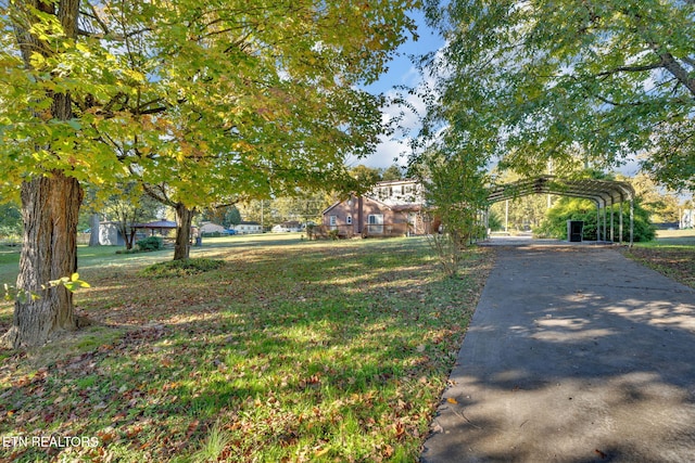 view of front facade featuring a front yard and a carport