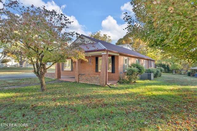 view of property exterior featuring a yard and central AC unit