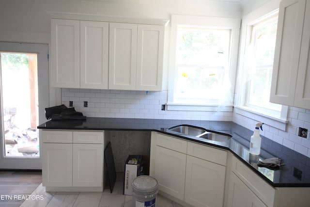 kitchen featuring white cabinets and backsplash