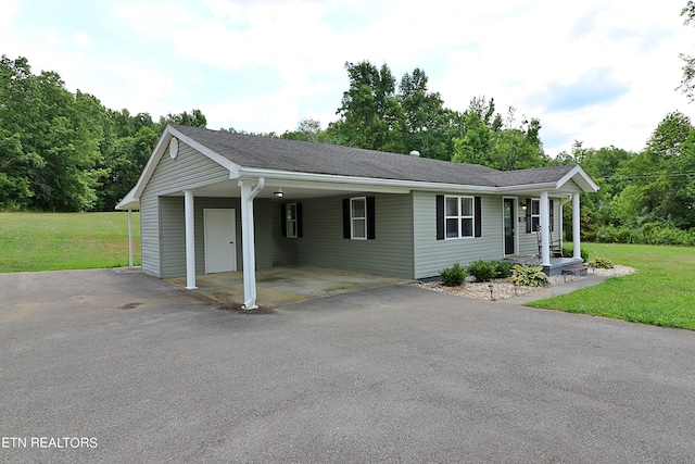 ranch-style house featuring a front yard and a carport