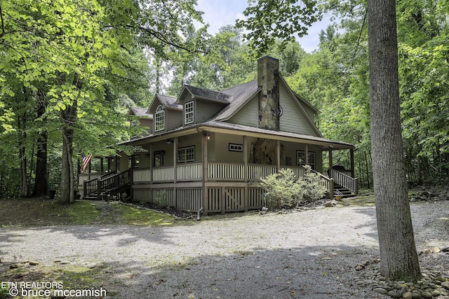 view of side of home with a porch