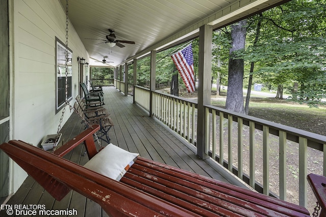 wooden deck featuring ceiling fan and a porch