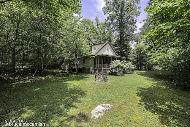 view of yard featuring a sunroom