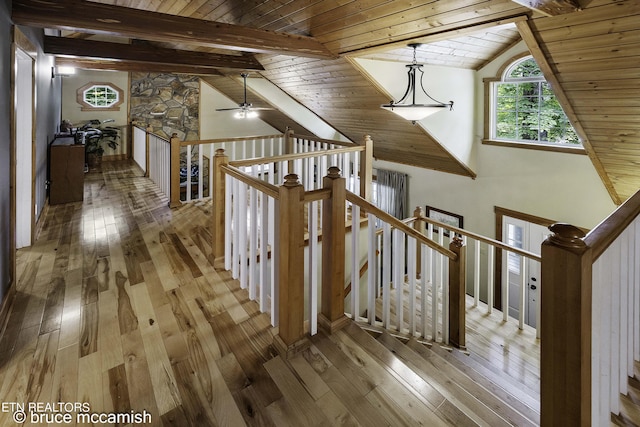 corridor featuring wood ceiling, light hardwood / wood-style floors, and vaulted ceiling with beams