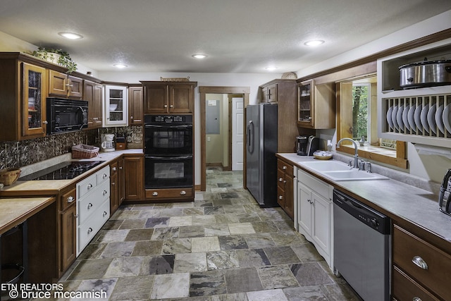 kitchen featuring decorative backsplash, sink, and black appliances