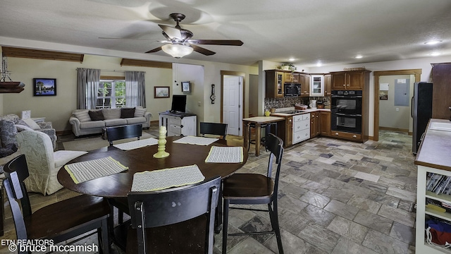 dining area with ceiling fan and a textured ceiling