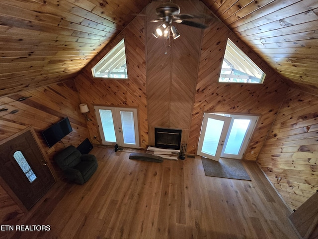 unfurnished living room with french doors, wooden ceiling, and hardwood / wood-style floors