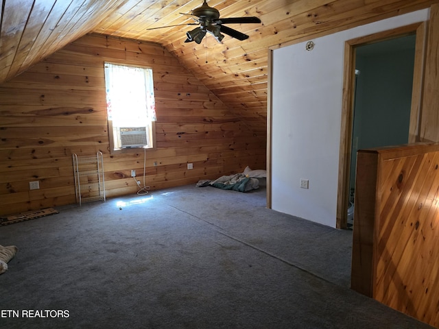 additional living space with carpet, wood ceiling, ceiling fan, wooden walls, and lofted ceiling