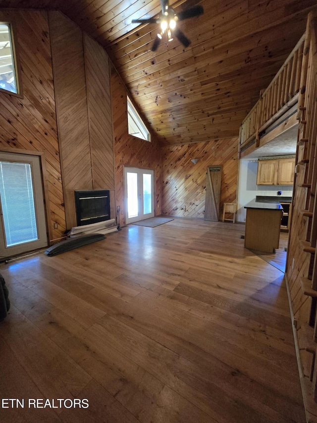 unfurnished living room with wooden ceiling, high vaulted ceiling, french doors, hardwood / wood-style flooring, and ceiling fan