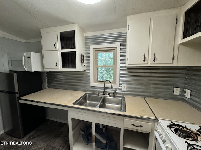 kitchen with tasteful backsplash, sink, white cabinets, and white appliances