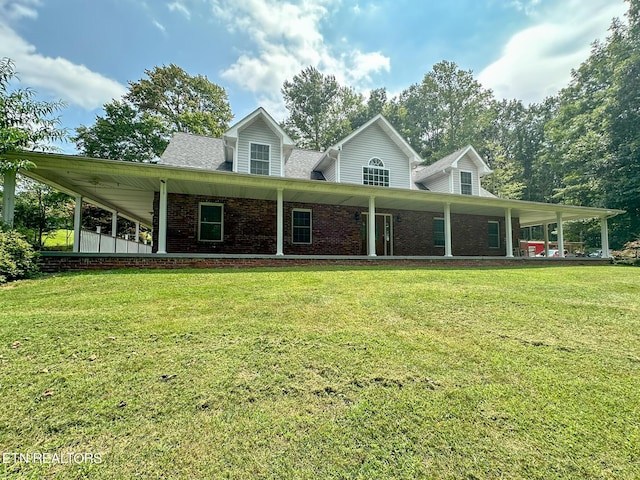 country-style home with a front yard and brick siding