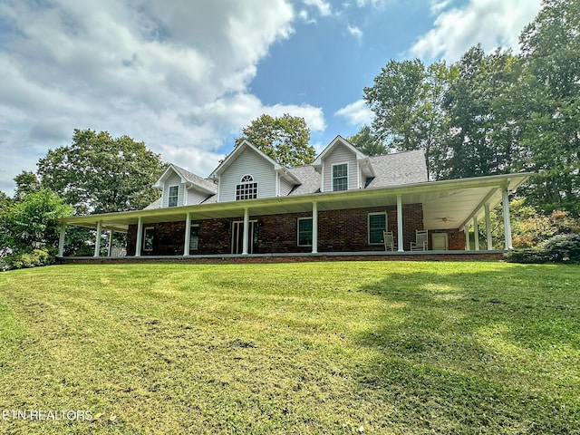 farmhouse-style home featuring brick siding and a front yard