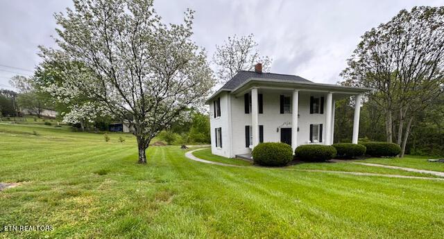 696 Forge Ridge Rd, Harrogate, TN 37752 - view of front of property featuring a front lawn, a chimney, and stucco siding