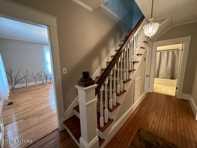 696 Forge Ridge Rd, Harrogate, TN 37752 - staircase with wood-type flooring, crown molding, and a chandelier