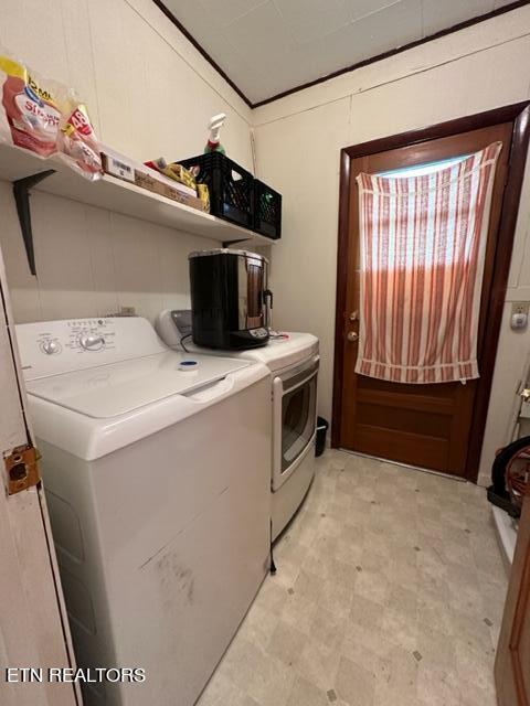 clothes washing area with washer and clothes dryer